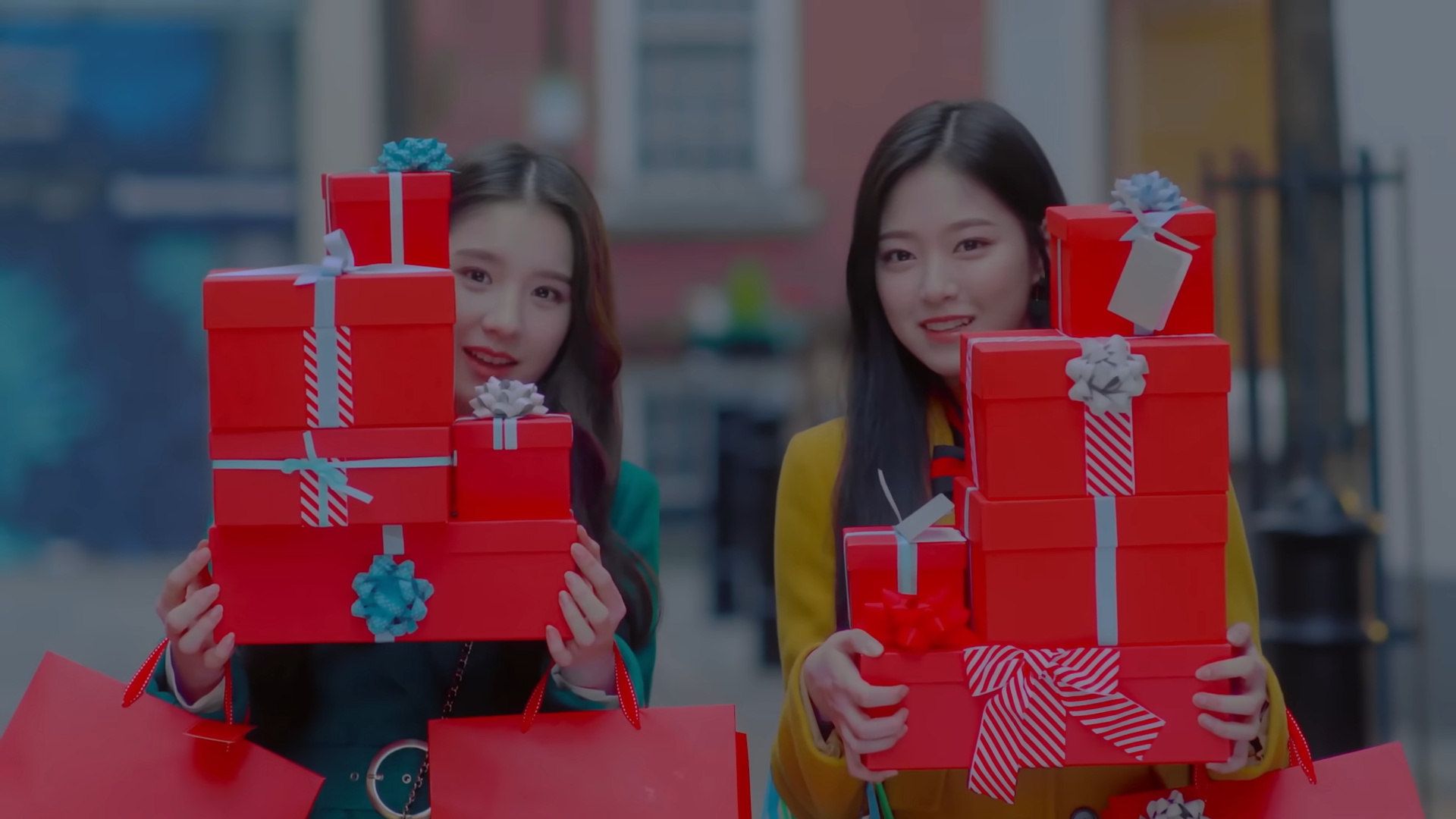 Heejin and Hyunjin holding presents.